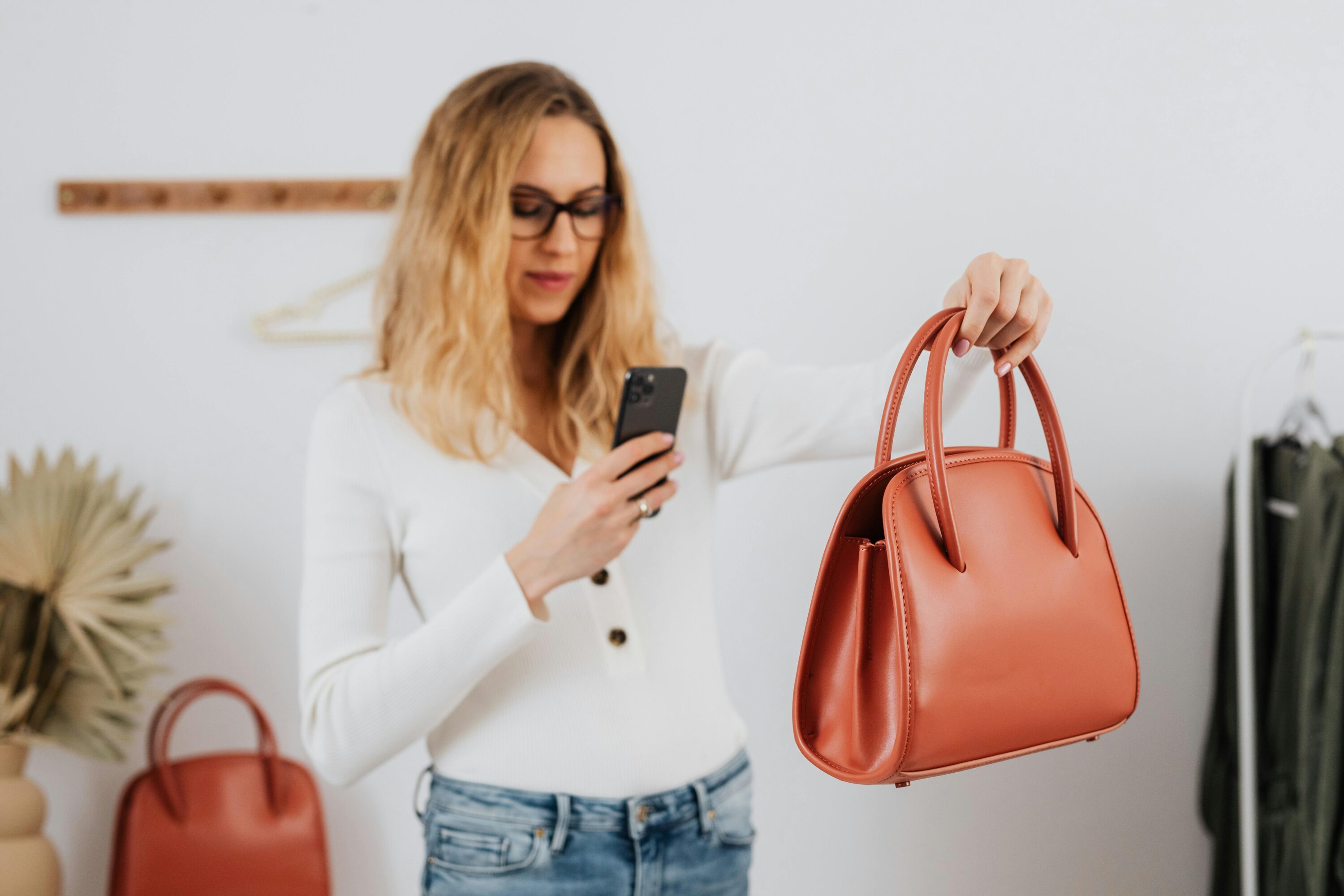 Woman taking photo of bag to optimise the product for visual search