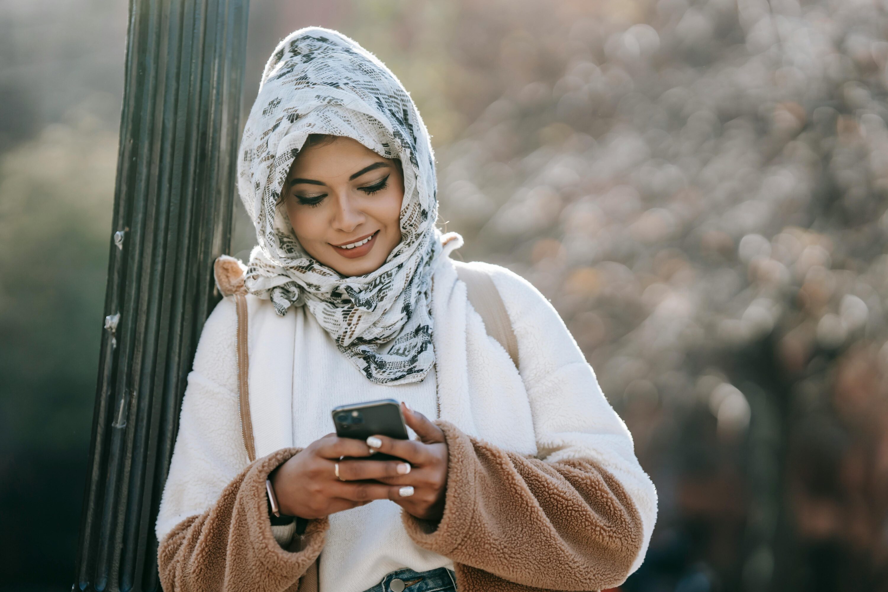 Woman looking at her phone and smiling.